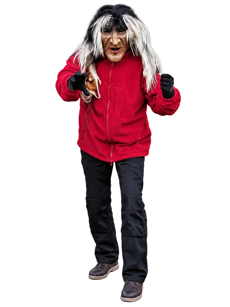 Huzler Male im Häs Huzler Male mit markanter Maske, rotem Oberteil und Fellstulpen.