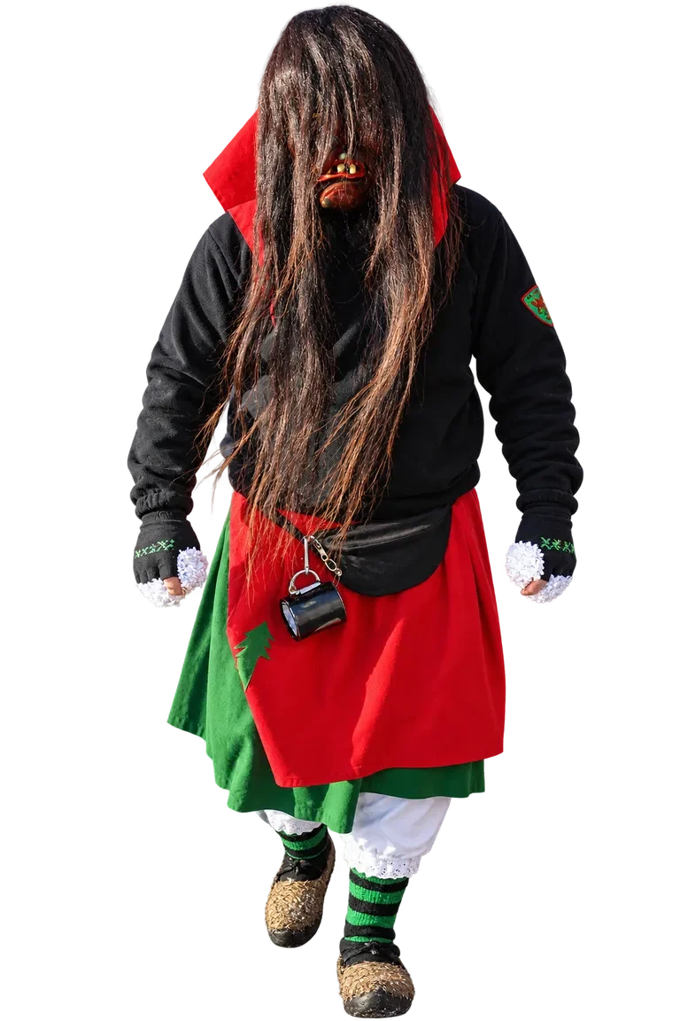 Huzler Hexa im traditionellen Häs Huzler Hexa im traditionellen Häs mit Maske und langen dunklen Haaren.